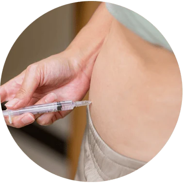 Woman receiving hormone injection for ovarian stimulation